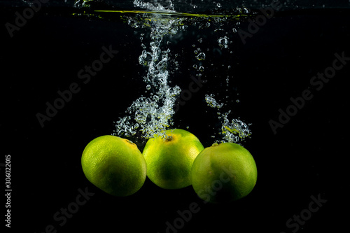 three tangerines in the water