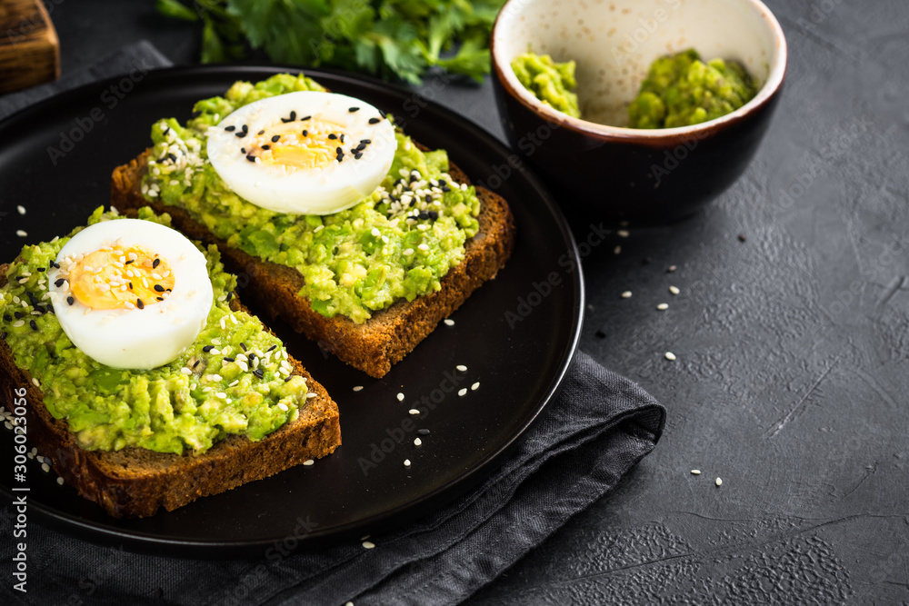 Avocado Sandwiches on black background. Avocado Sandwiches on black background.