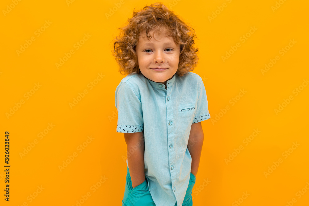 European red-haired boy in a light blue T-shirt on a yellow background European red-haired boy in a light blue T-shirt on a yellow background