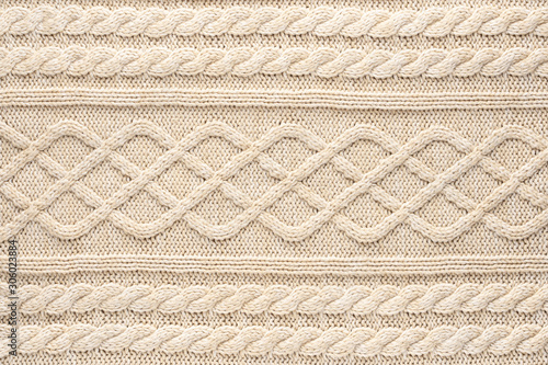 Beige Knitwear Fabric Texture with Pigtails. Beige Knitted Background.
