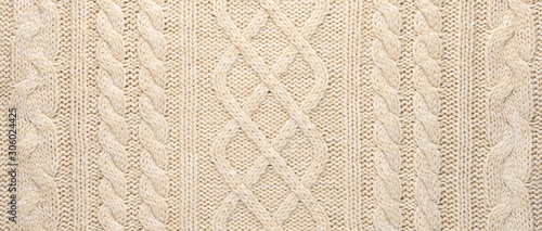 Beige Knitwear Fabric Texture with Pigtails. Beige Knitted Background.
