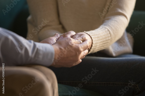 Old husband holding hands of senior beloved wife closeup image © fizkes