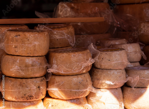 Assorted pieces of cheese for sale at a traditional market stall