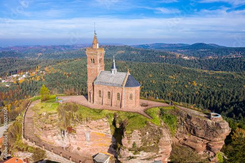 Beautiful autumn aerial view of St. Leon chapel dedicated to Pope Leo IX atop of Rocher de Dabo or Rock of Dabo  red sandstone rock butte  and Moselle-Vosges mountains and valleys. Lorraine  France