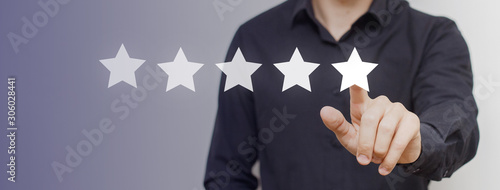 User giving 5 star for a good service or product. Review from a businessman, rating the level of satisfaction and general result in management, business or performance of the entity. photo