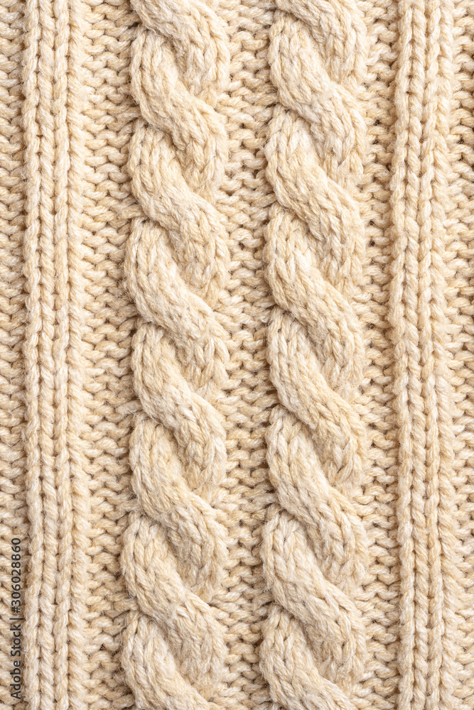 Beige Knitwear Fabric Texture with Pigtails. Beige Knitted Background. Beige Knitwear Fabric Texture with Pigtails. Beige Knitted Background.