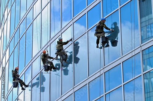 Industrial climbers wash windows of skyscraper