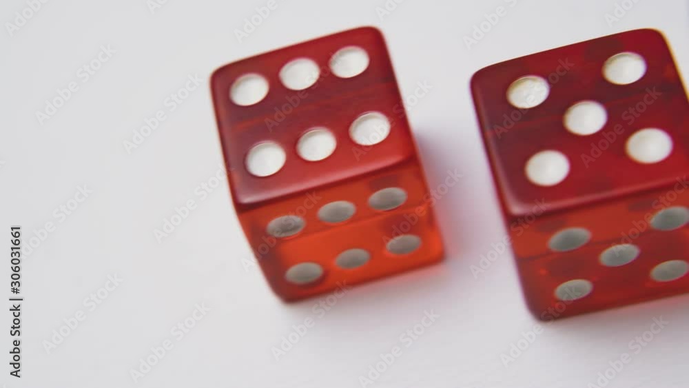 beautiful red transparent plastic dices with white spots lie on light background extreme close view beautiful red transparent plastic dices with white spots lie on light background extreme close view
