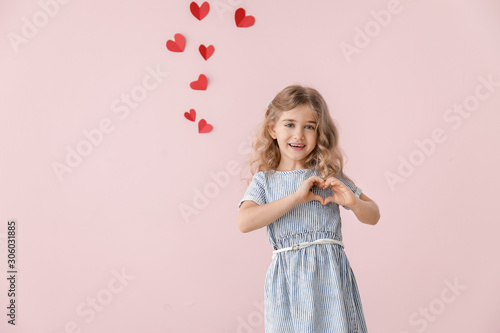 Cute little girl holding ha...