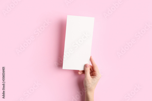 Female hand with blank menu on color background