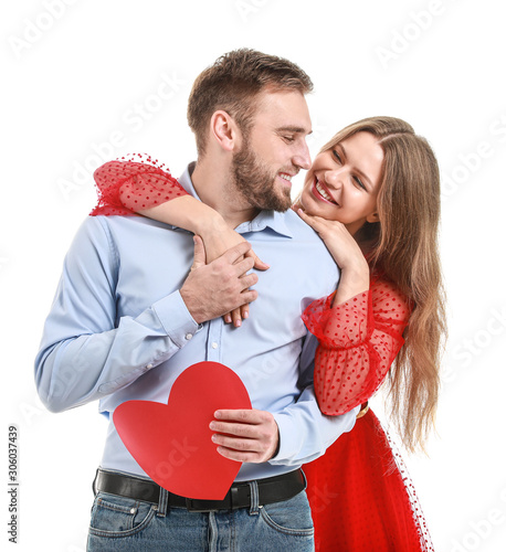 Happy young couple with red heart on white background. Valentine's Day celebration