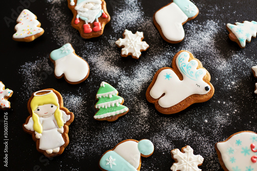 Christmas gift gingerbread on dark background. Christmas gingerbread cookies with icing sugar. Top view