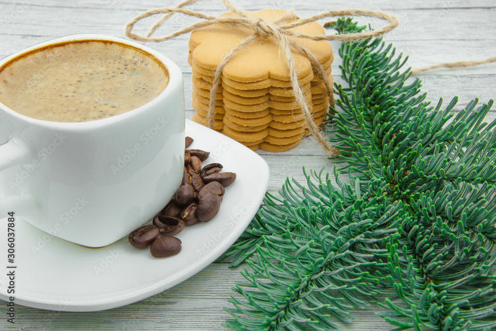 Cup of coffee and Christmas cookies, on the background of fir branches. The holiday comes to us. Cup of coffee and Christmas cookies, on the background of fir branches. The holiday comes to us.