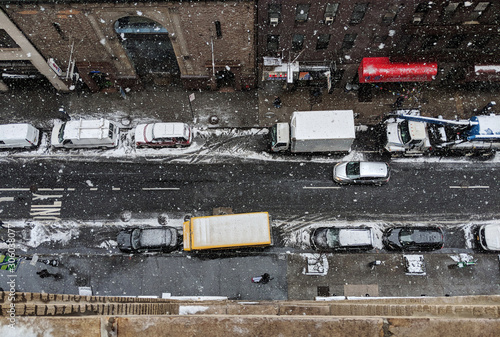 Photography Looking down on the street with parked cars on winter day in New York City