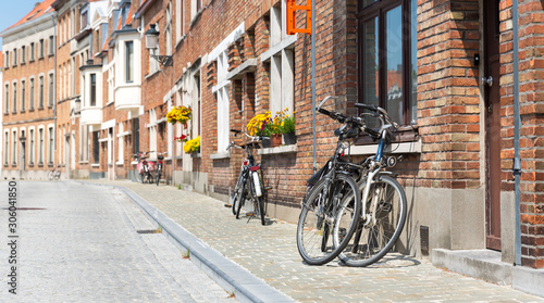 Bicycles at ancient building facade, European town © Nomad_Soul