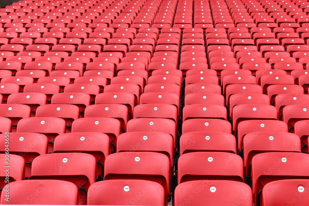 Red plastic seats in a stadium. Liverpool FC fan zones open four hours before kick-off on a match day and are great place for supporters to soak up the atmosphere of Anfield. Liverpool, UK Red plastic seats in a stadium. Liverpool FC fan zones open four hours before kick-off on a match day and are great place for supporters to soak up the atmosphere of Anfield. Liverpool, UK