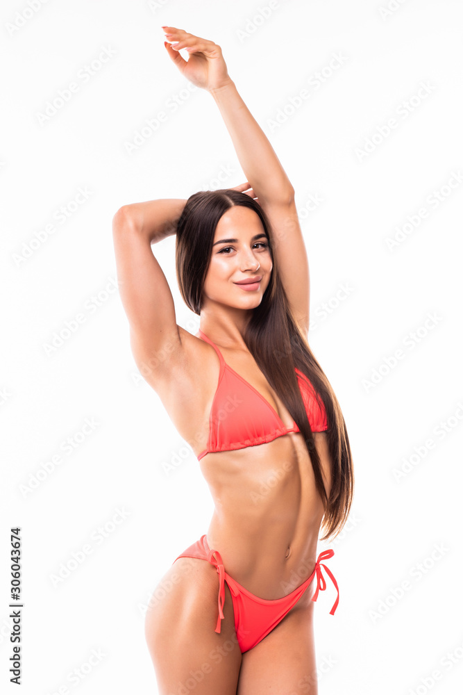 Obraz premium Gorgeous young woman in bikini posing isolated over a white background