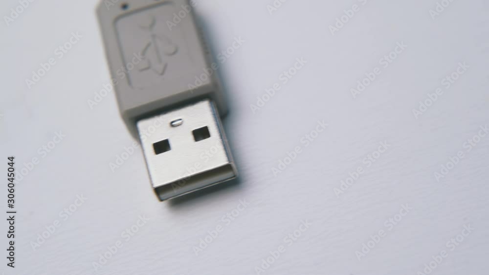 motion past grey usb cable for devices connection to computer on empty white background extreme close view motion past grey usb cable for devices connection to computer on empty white background extreme close view