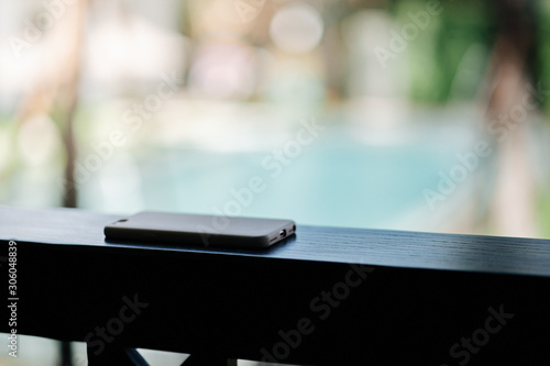 Mobile phones placed face down on wooden beams