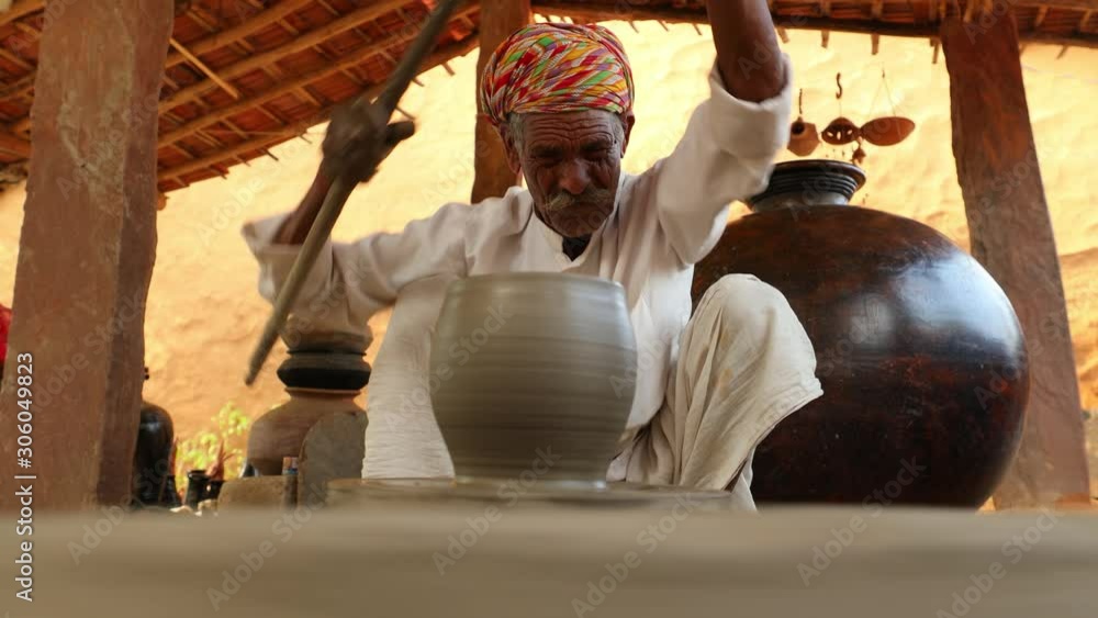 Potter at work makes ceramic dishes. India, Rajasthan. Potter at work makes ceramic dishes. India, Rajasthan.