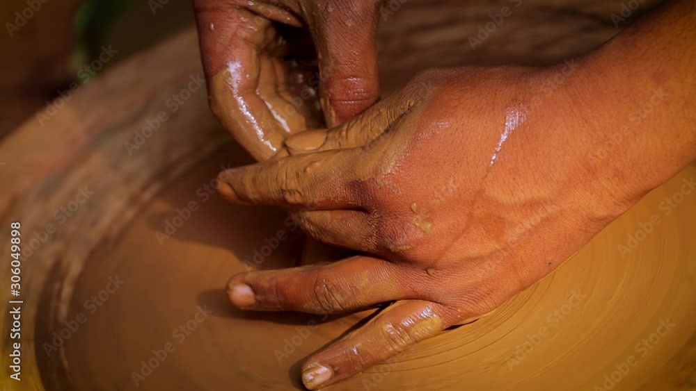 Potter at work makes ceramic dishes. India, Rajasthan. Potter at work makes ceramic dishes. India, Rajasthan.