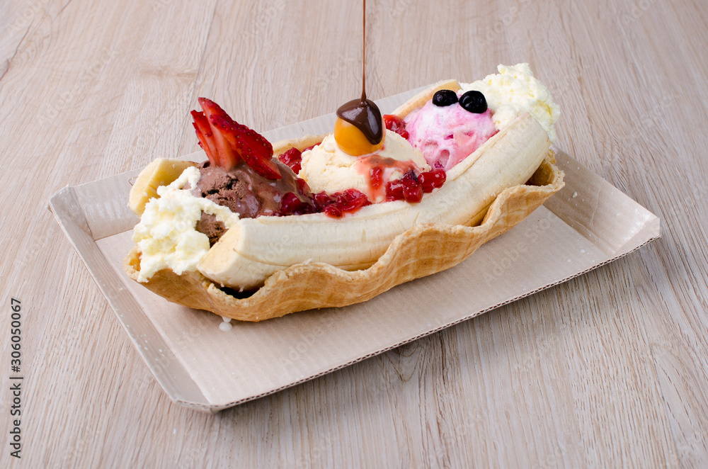 banana split with chopped fruits and sauces