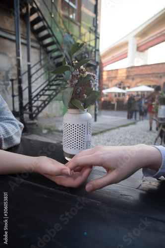 Two girls touching their hands on a table photo