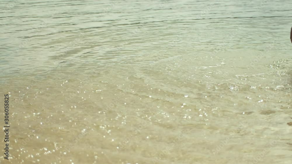 Woman splashing clear ocean water Woman splashing clear ocean water