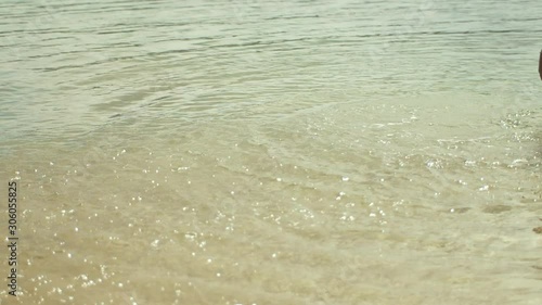 Woman splashing clear ocean water photo