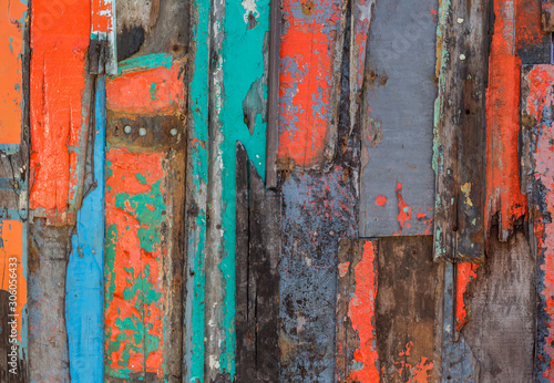 Patterned and textures background of brightly colored panels of weathered painted wooden boards.