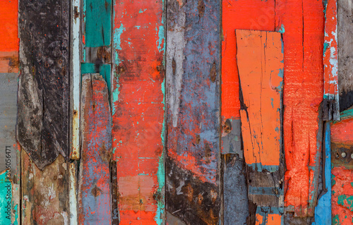 Patterned and textures background of brightly colored panels of weathered painted wooden boards.