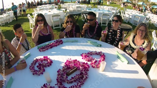 Family Cheers Drinks At A Luau