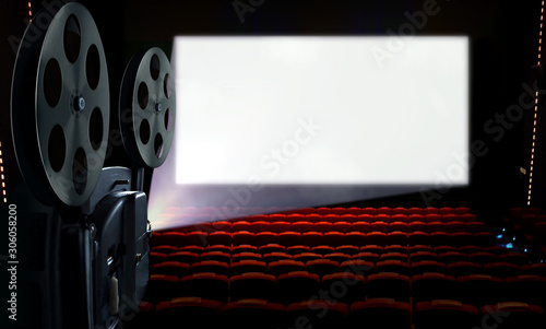 Projector in cinema hall with blank white screen photo