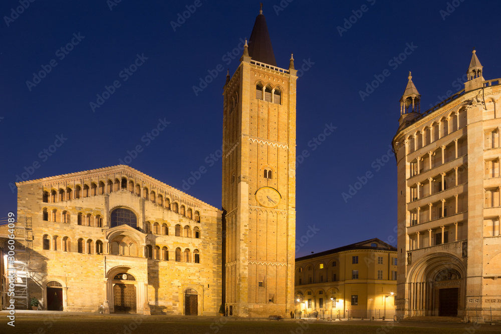City square with Baptistery and Cathedral of night Parma in Italy