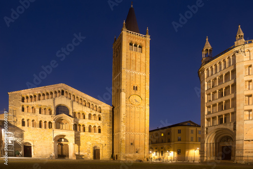 City square with Baptistery and Cathedral of night Parma in Italy