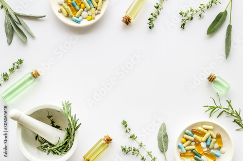 Apothecary of natural wellness and self-care. Herbs and medicine on white background top view frame copy space photo