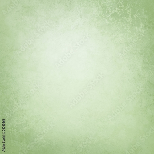 Green background texture, old distressed vintage grunge in faded white center and pastel green border design that is blank with copyspace