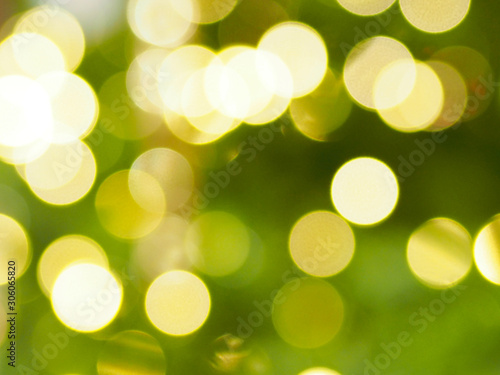 gold bokeh on green color for Christmas background.