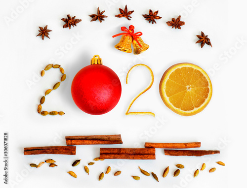 New Year 2020. 3D numbers with spices, grapefruit, bells and red ball on a white background. Christmas card