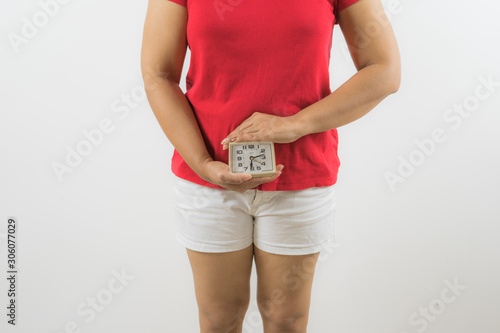 closeup on alarm clock in hands of women period day