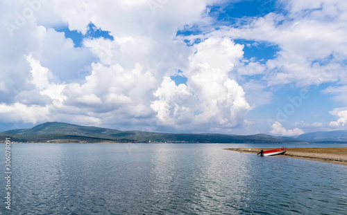 Blue sky, white clouds, calm sea and beach.