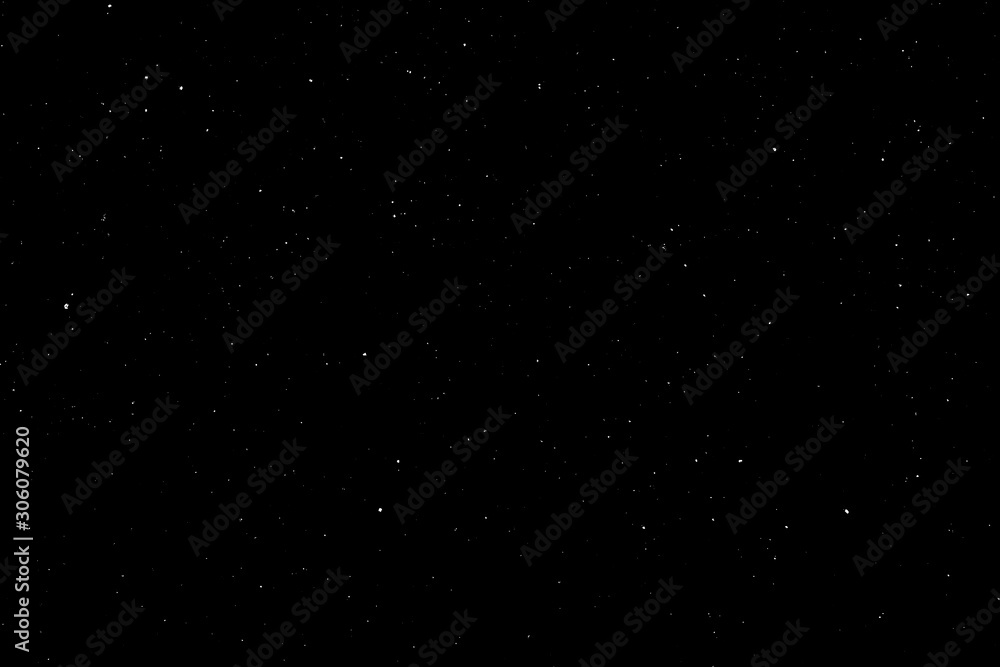 WHITE BOKEH ON A BLACK BACKGROUND. LIGHT SPOTS TEXTURE. FALLING SNOW. STAR SKY.