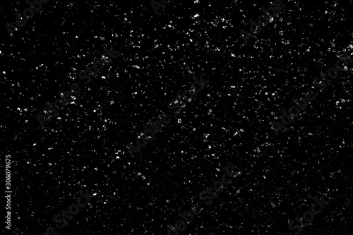 WHITE BOKEH ON A BLACK BACKGROUND. LIGHT SPOTS TEXTURE. FALLING SNOW. STAR SKY.
