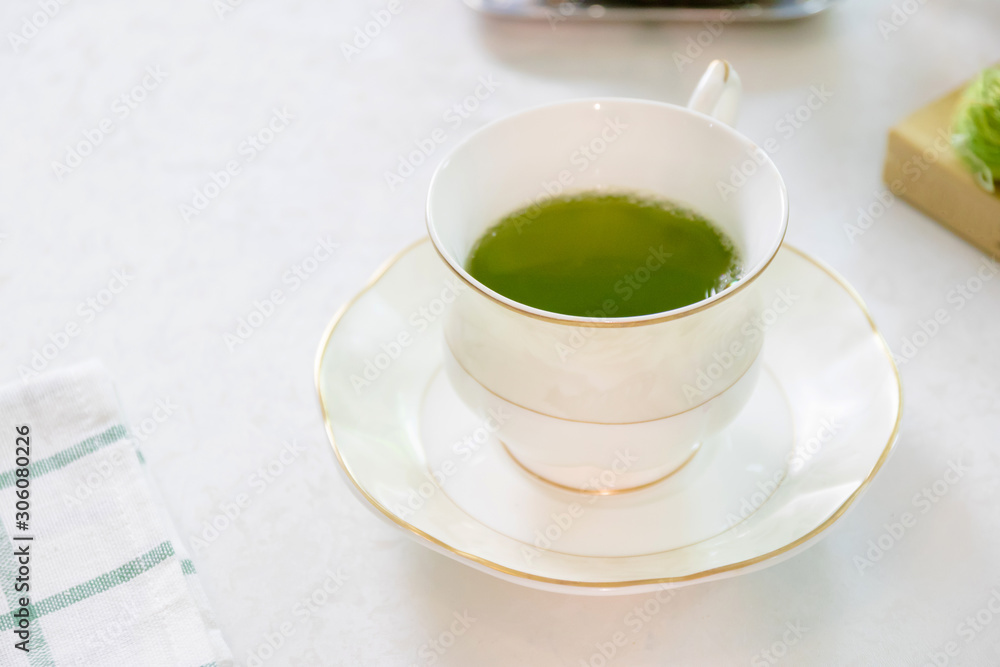 Porcelain cup of green tea on table in afternoon. Porcelain cup of green tea on table in afternoon.