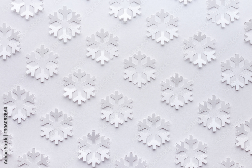 White winter background made from snowflakes cut out on a sheet of paper. White winter background made from snowflakes cut out on a sheet of paper.