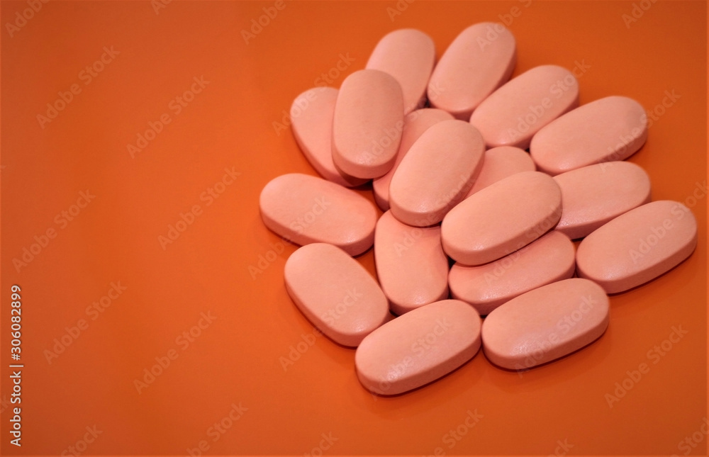 vitamin pills on orange background vitamin pills on orange background