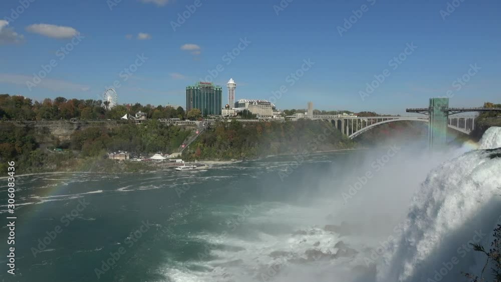 Niagara, United States - October 19, 2019: 4K. View of the Niagara Falls with a rainbow from the heights, in the American part. Many tourists from all over the world visit this natural place. Niagara, United States - October 19, 2019: 4K. View of the Niagara Falls with a rainbow from the heights, in the American part. Many tourists from all over the world visit this natural place.