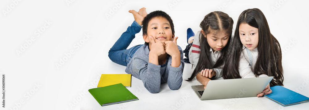 Asian Little kid with colourful books on white background, Education Learning School Concept