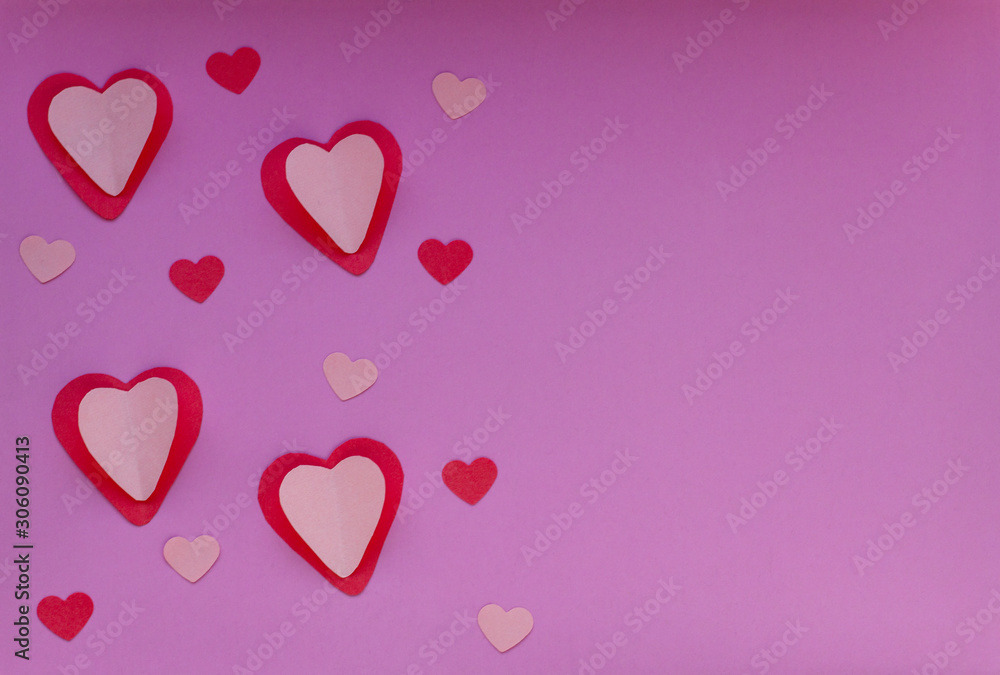 Red and pink hearts on a purple background. Valentin's Day, top view. Copy space
