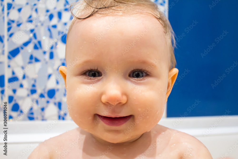 Child plays with a shower in the bathroom Child plays with a shower in the bathroom